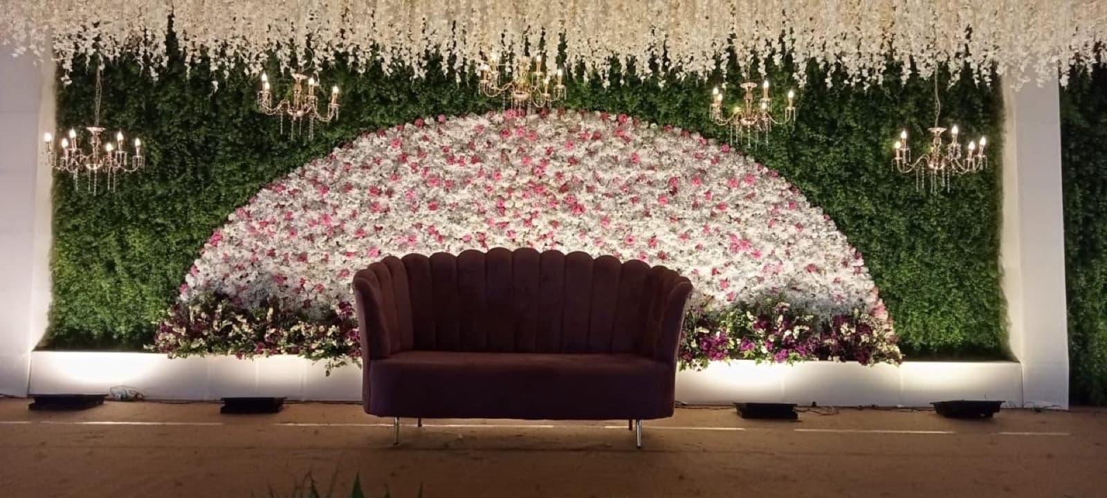 Floral stage backdrop in gold and greenery
